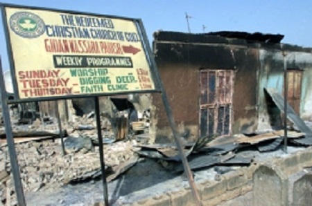 This file photo shows a sign pointing towards a church burned down by riots in northern Nigeria. This file photo shows a sign pointing towards a church burned down by riots in northern Nigeria.